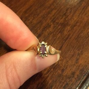 Gold ring with purple stone